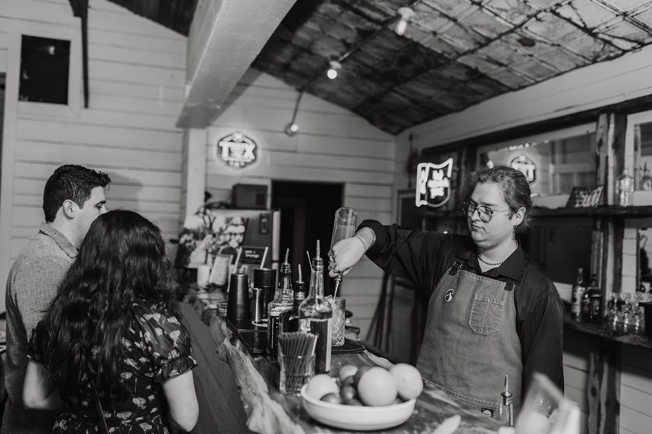 Peak Beverage bartender serving specialty cocktails at a Willow Sky Ranch wedding — trusted bar service vendor near Fredericksburg, Texas Hill Country
